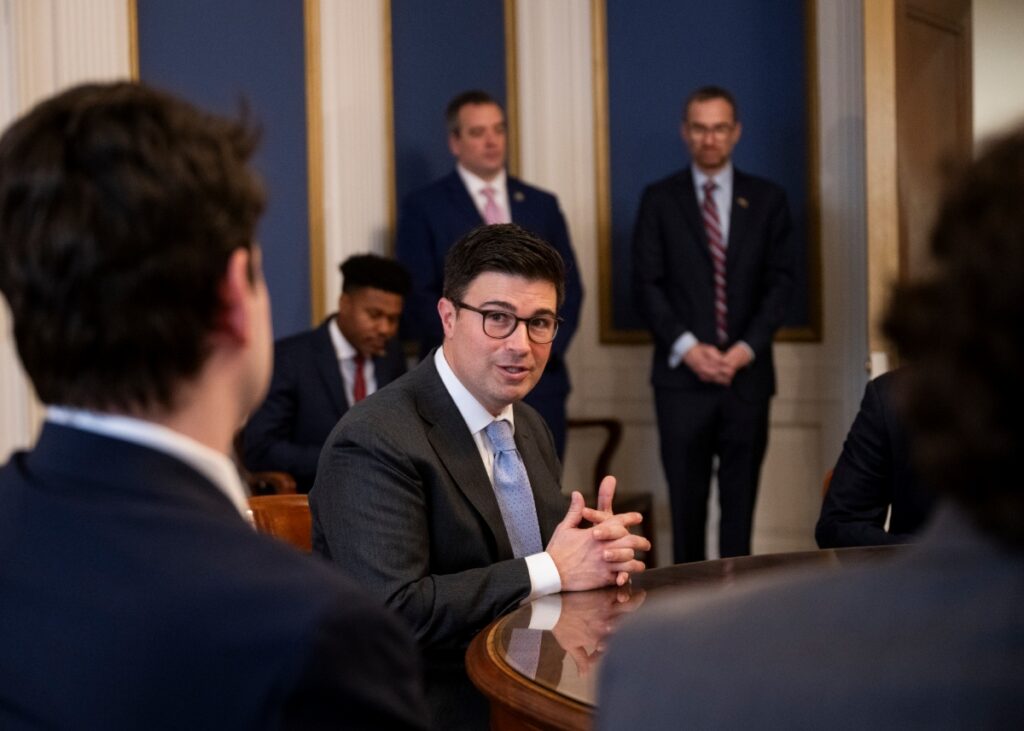 Mayor Corey O'Connor engaging in a meeting with staff and community members to discuss Pittsburgh city development and challenges.