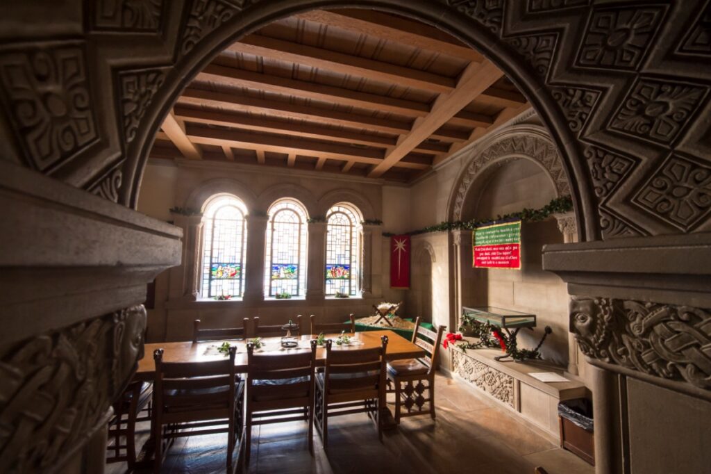 Ornate limestone doorway and traditional wood furniture in the Irish Nationality Room, reflecting medieval architectural styles.