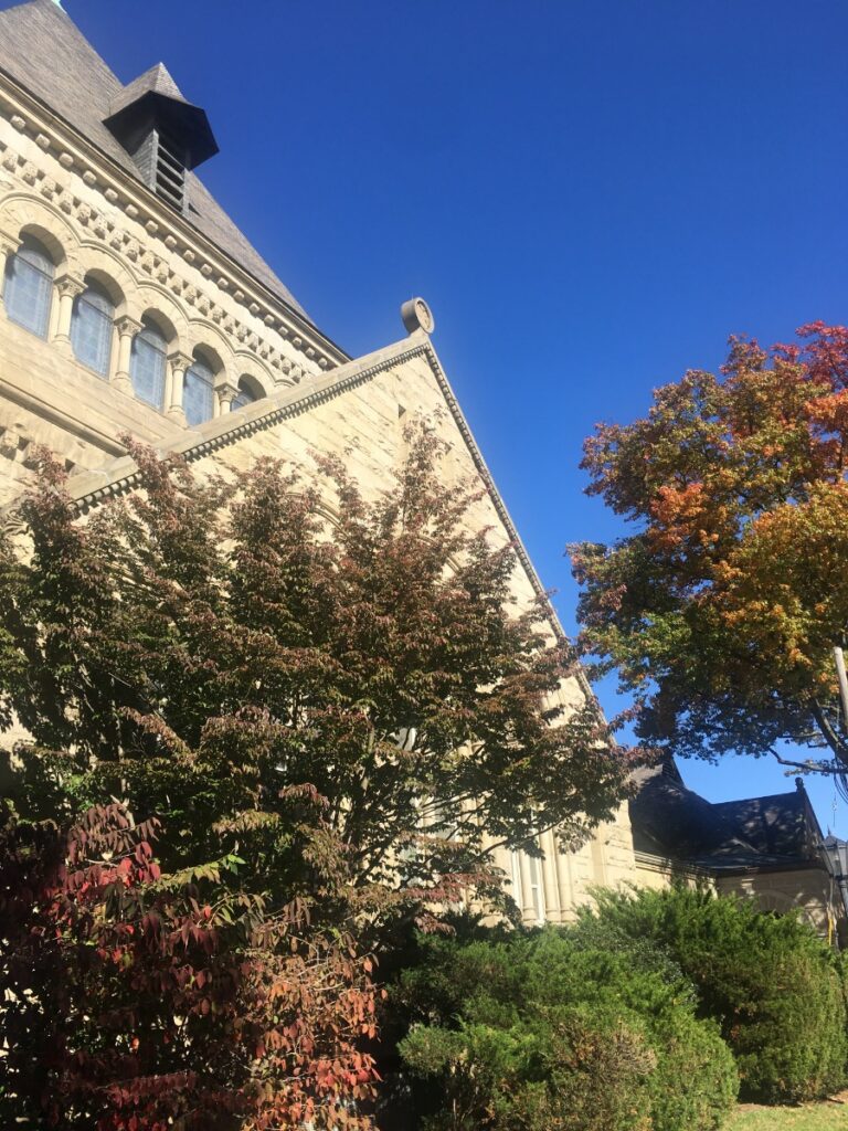 Exterior stone architecture of Shadyside Presbyterian Church in Pittsburgh under a blue sky.