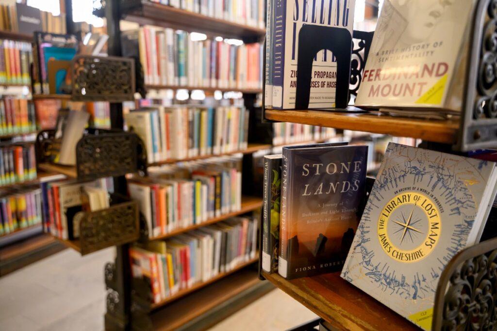 Inside the Carnegie Library of Pittsburgh Lawrenceville branch with books displayed on wooden shelves.