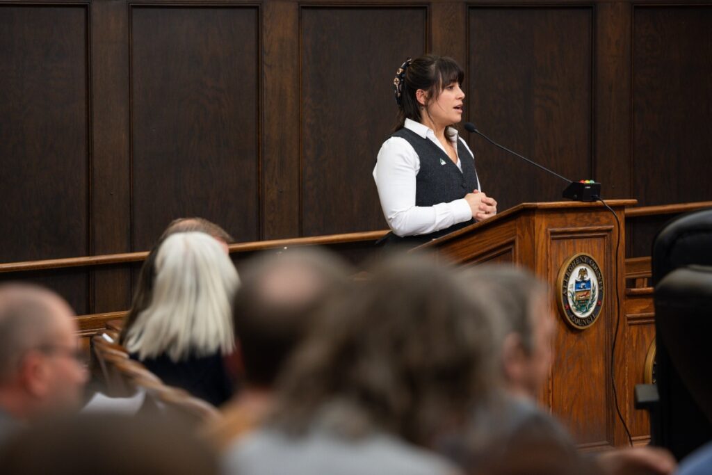 Allegheny County Executive Sara Innamorato speaking at the podium during an official County Council meeting in Pittsburgh.