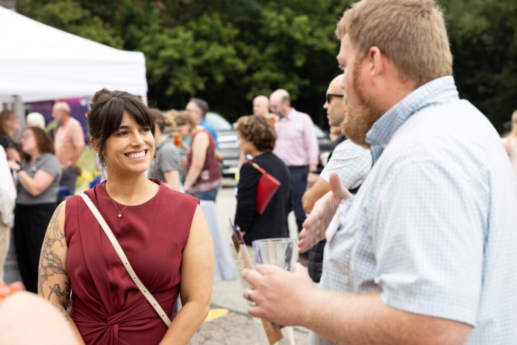 Allegheny County Executive Sara Innamorato smiling and networking with residents at a local County Connect community event.