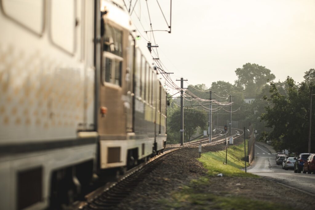 Pittsburgh light rail train traveling along tracks through the suburban South Hills area.